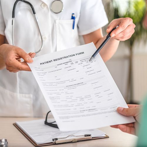 Doctor receiving patient registration form