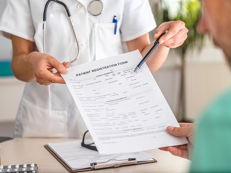 Doctor receiving patient registration form